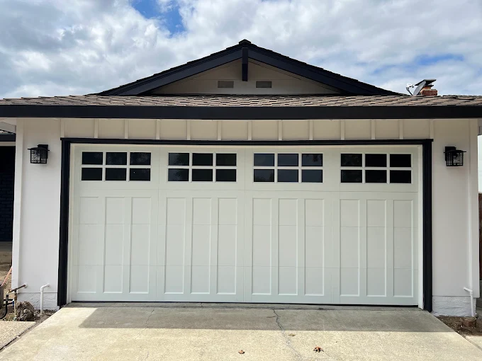 White carriage-style garage door with glass panel windows